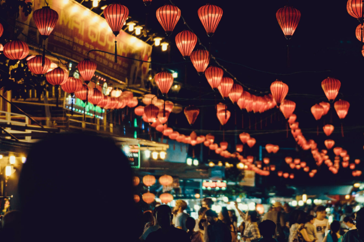 Crowds of visitors exploring Nha Trang Night Market at night in 2025, under vibrant lantern lights